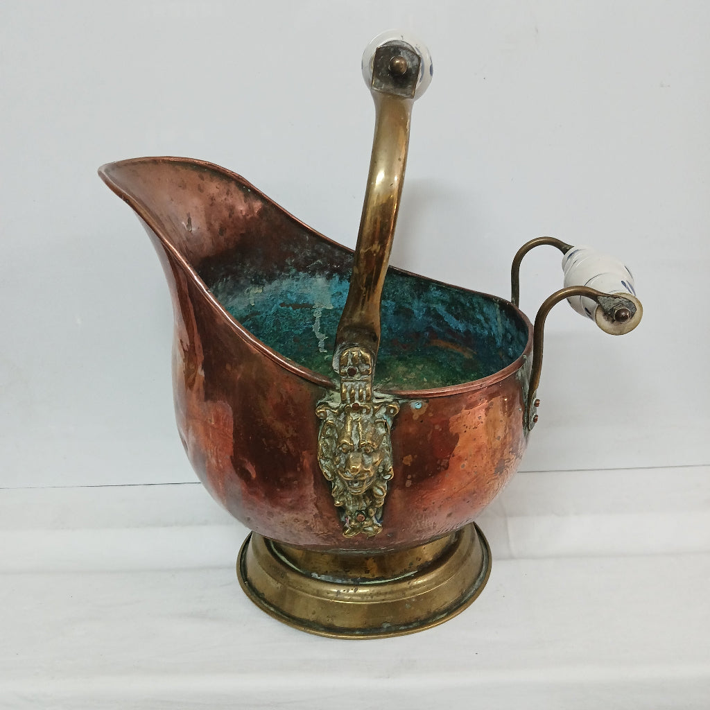 Copper helmet shaped coal scuttle on white at French Originals antiques