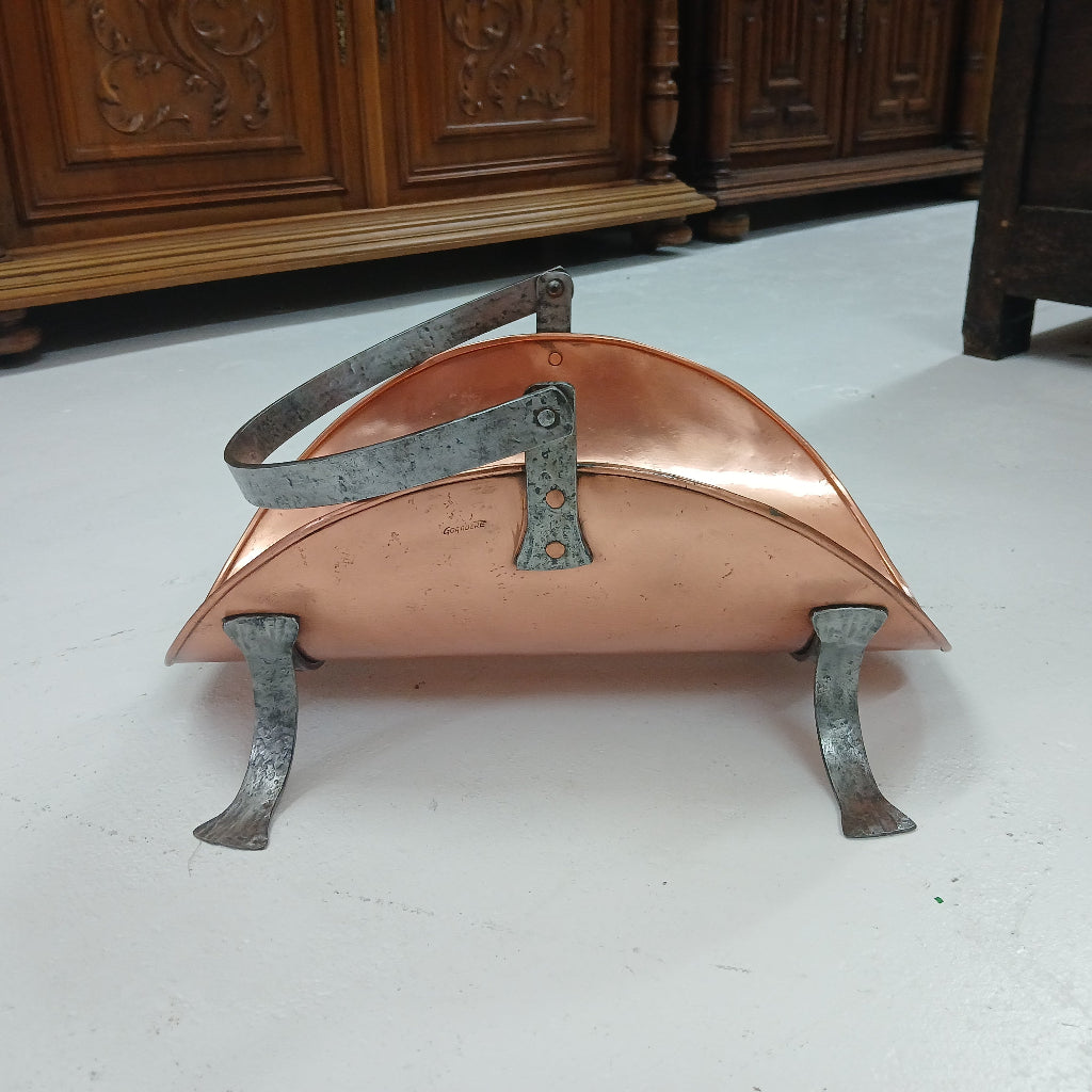 Copper and iron wood carrier on white floor at French Originals antiques