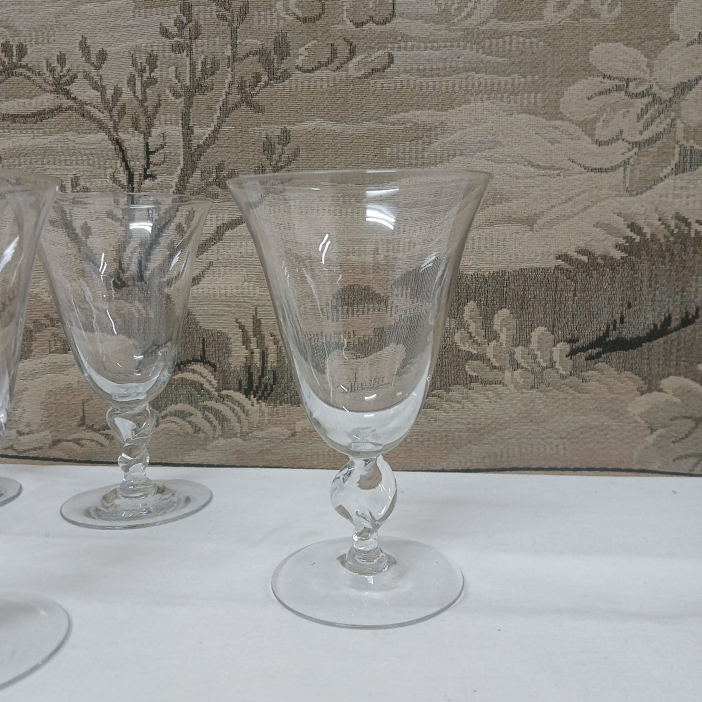 Set of clear glass goblets on a textured surface at French Originals antiques