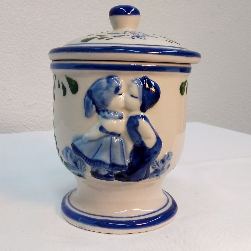 couple kissing on French blue storage jar at French Originals NZ